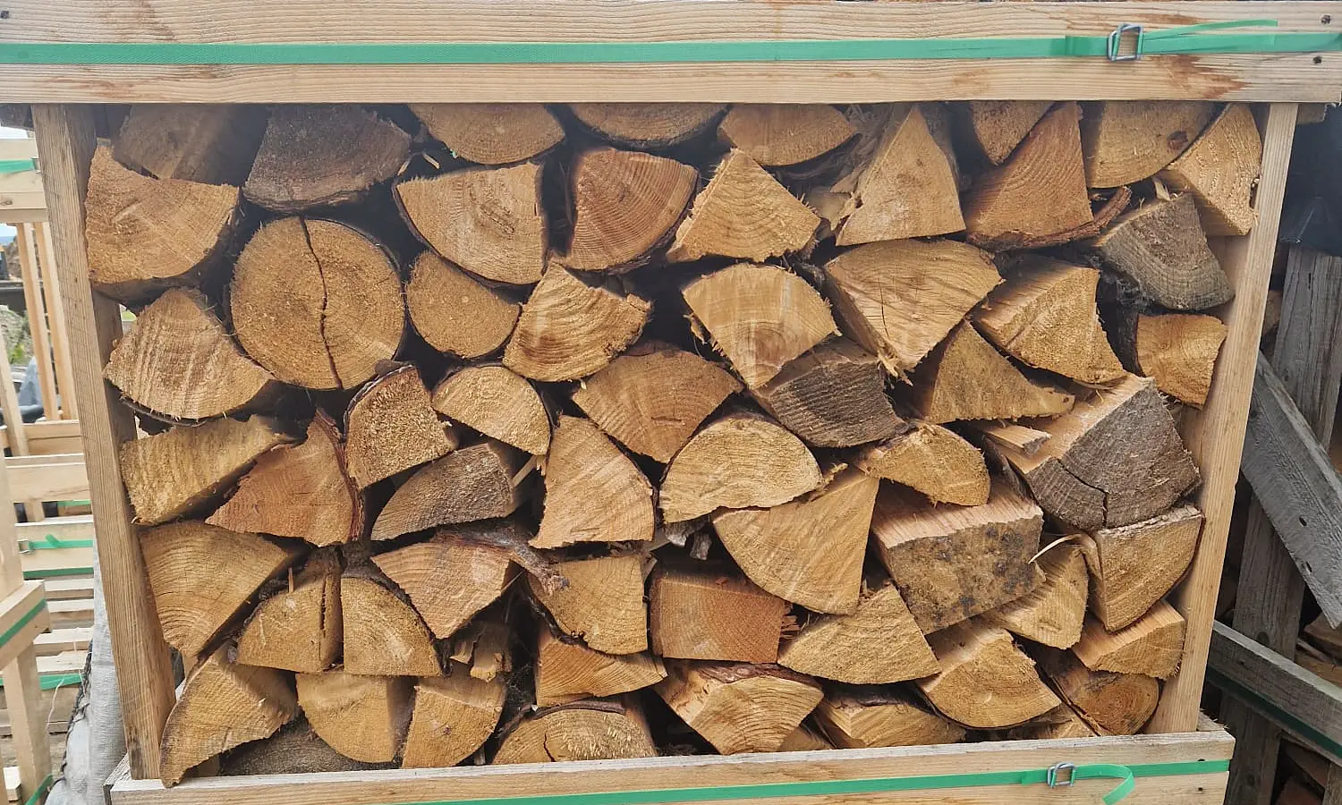 Split softwood logs stacked in a crate at Moray Logs, Elgin